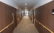 廊下　一直線の広い廊下で両側に手すりが設置されて、床はカーペット仕上げで高級感のある廊下です。（リヤンドファミーユ）